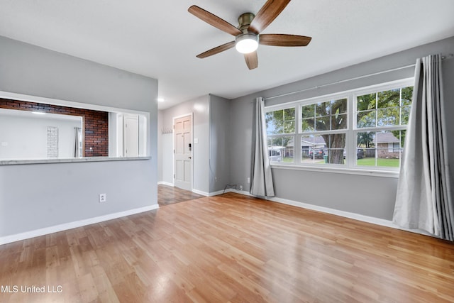 unfurnished room with ceiling fan and light wood-type flooring