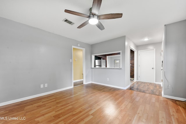 empty room with light hardwood / wood-style flooring and ceiling fan