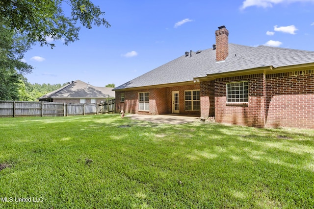 452 Pecan Cir, Brandon, MS 39042 - back of property with a chimney, a patio area, roof with shingles, and brick siding