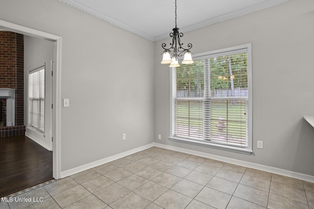 452 Pecan Cir, Brandon, MS 39042 - unfurnished dining area featuring plenty of natural light, a chandelier, crown molding, and light tile patterned flooring