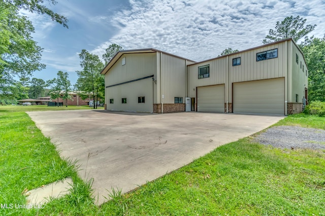 view of home's exterior with a garage and a lawn