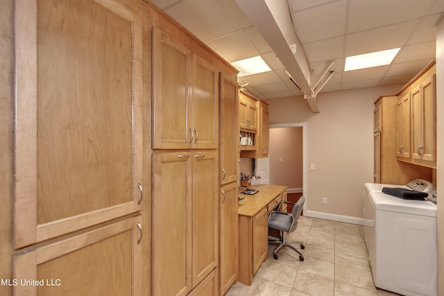 office area with a drop ceiling, washer / clothes dryer, and light tile patterned flooring