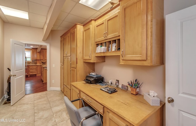 904 Northwood Cir, Brandon, MS 39047 - office featuring baseboards, a paneled ceiling, built in desk, and light tile patterned floors