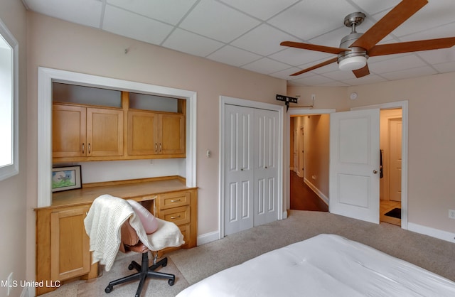 carpeted bedroom featuring a paneled ceiling and ceiling fan