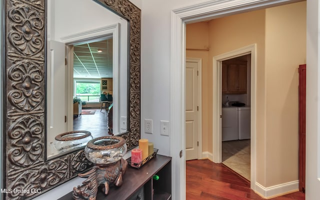 hallway featuring washer / clothes dryer and dark hardwood / wood-style flooring