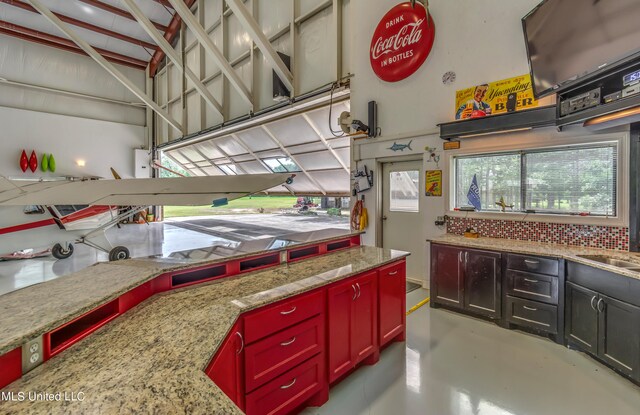 kitchen with decorative backsplash and light stone counters