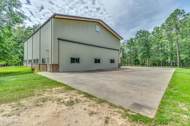 904 Northwood Cir, Brandon, MS 39047 - view of side of property with an outbuilding, a yard, a pole building, and brick siding