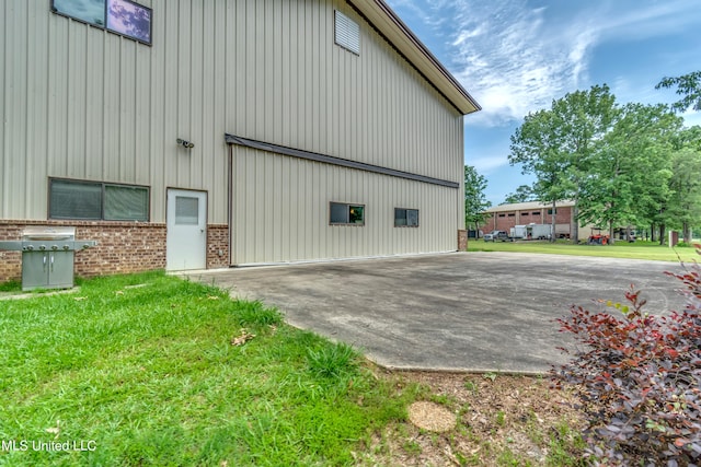 view of side of property with a lawn