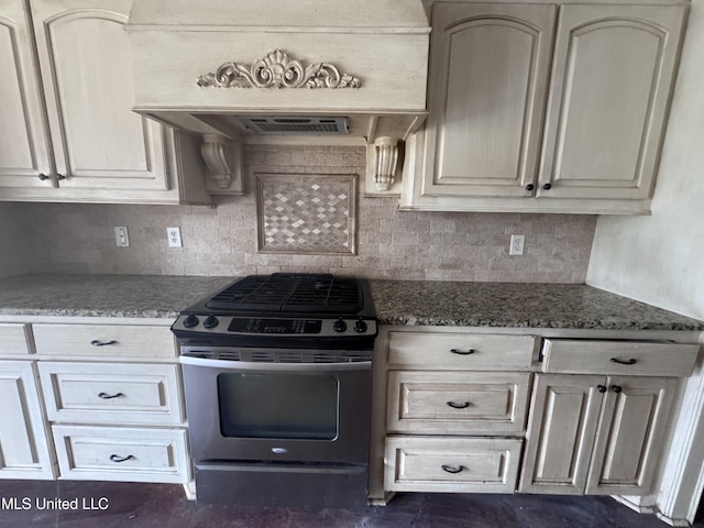 515 Belle Oak Pl, Brandon, MS 39042 - kitchen with stainless steel range with gas cooktop, tasteful backsplash, dark stone counters, and custom exhaust hood