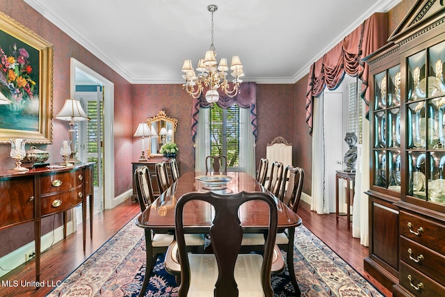 dining area featuring ornamental molding, a chandelier, and dark wood-type flooring