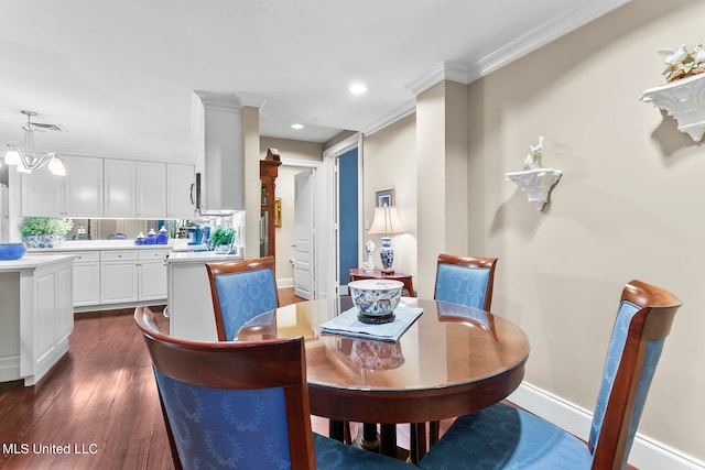 dining room with a notable chandelier, ornamental molding, and dark hardwood / wood-style flooring