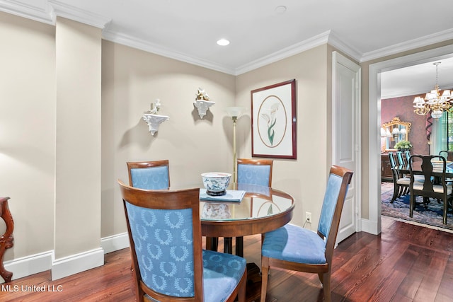 dining space featuring dark wood-type flooring, a notable chandelier, and crown molding