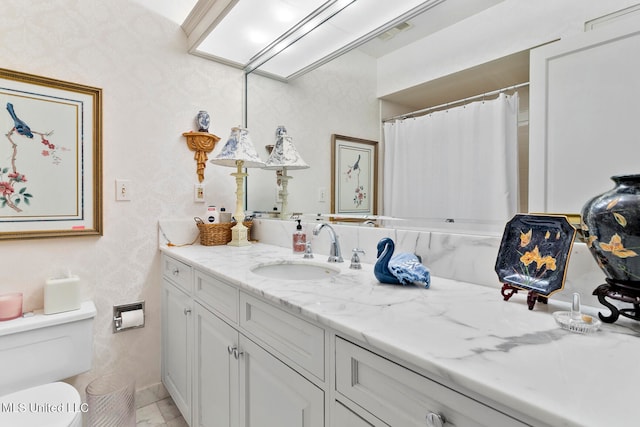 bathroom with vanity and toilet