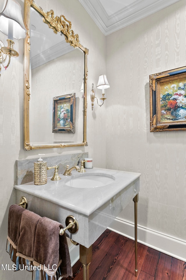 bathroom with vanity, ornamental molding, and hardwood / wood-style flooring