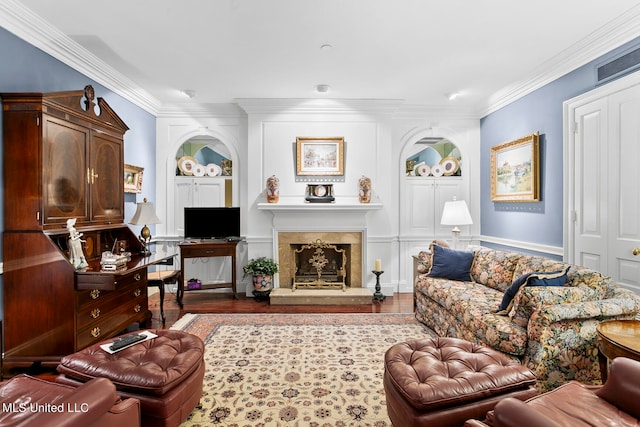 living room with ornamental molding, a high end fireplace, and hardwood / wood-style flooring