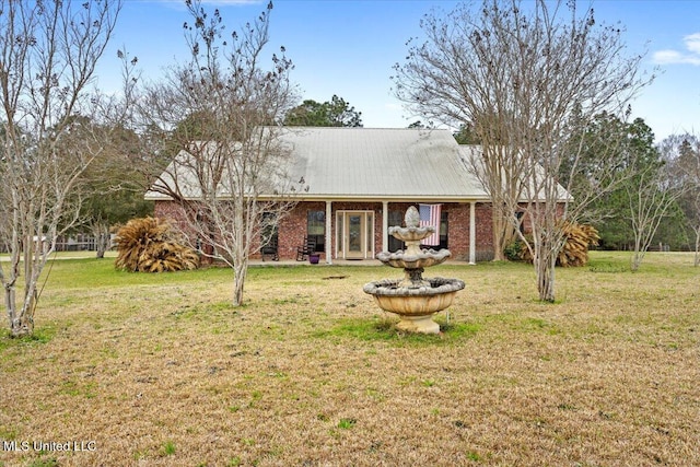 view of front of property with a front yard and brick siding