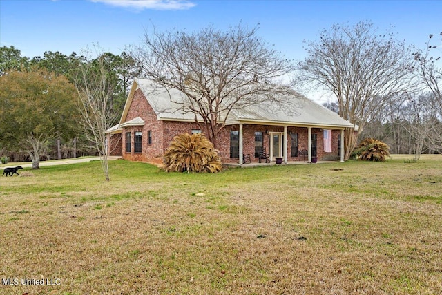 view of front of property with brick siding and a front lawn