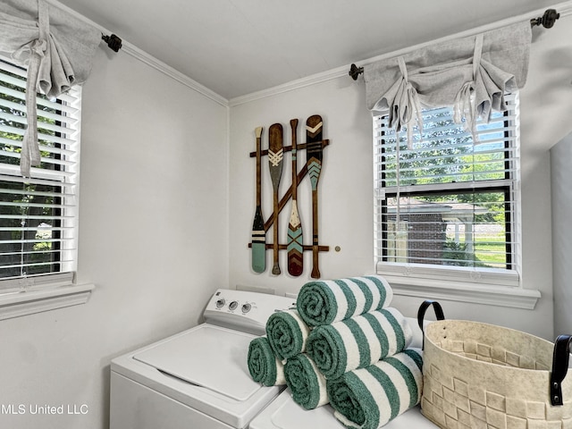 laundry area with washing machine and dryer and crown molding