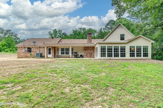 1597 Old Lake Rd, Brandon, MS 39042 - rear view of property with a chimney, a yard, brick siding, cooling unit, and a patio area