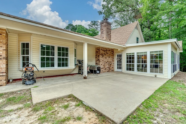 1597 Old Lake Rd, Brandon, MS 39042 - back of property featuring a patio, a chimney, and brick siding