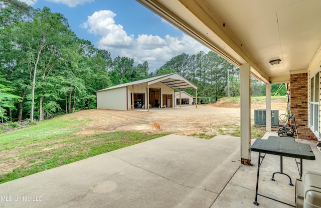 1597 Old Lake Rd, Brandon, MS 39042 - view of patio / terrace with a pole building, central air condition unit, an outbuilding, and view of scattered trees