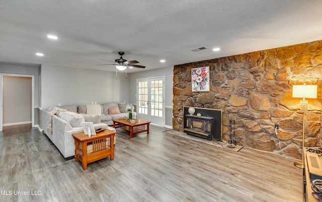 1597 Old Lake Rd, Brandon, MS 39042 - living area with ceiling fan, baseboards, wood finished floors, a wood stove, and recessed lighting