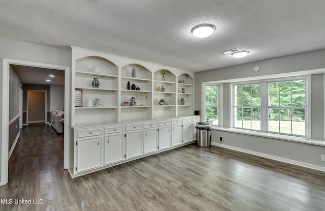 1597 Old Lake Rd, Brandon, MS 39042 - empty room featuring a textured ceiling, wood finished floors, and baseboards