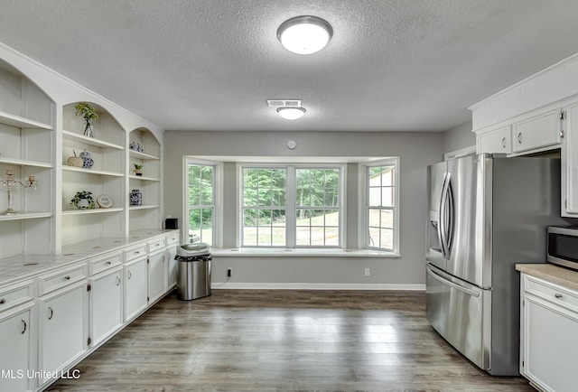 1597 Old Lake Rd, Brandon, MS 39042 - kitchen featuring appliances with stainless steel finishes, a textured ceiling, healthy amount of natural light, dark wood-style floors, and light countertops