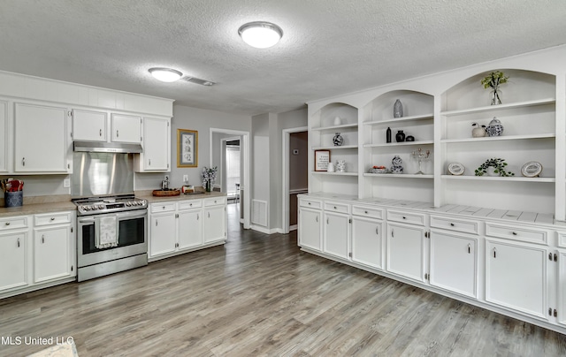 1597 Old Lake Rd, Brandon, MS 39042 - kitchen featuring gas stove, under cabinet range hood, open shelves, a textured ceiling, and white cabinetry