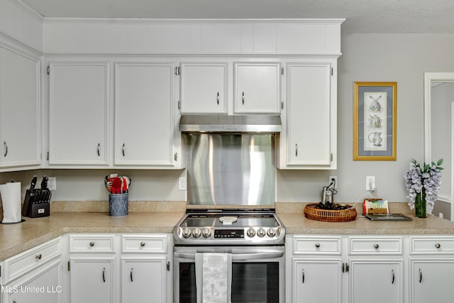 1597 Old Lake Rd, Brandon, MS 39042 - kitchen with stainless steel electric stove, under cabinet range hood, light countertops, and white cabinetry