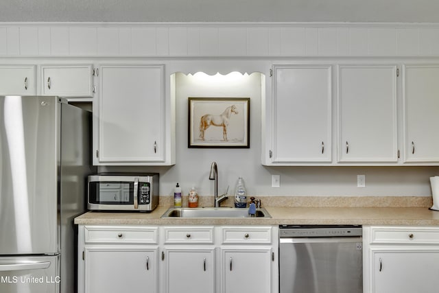 1597 Old Lake Rd, Brandon, MS 39042 - kitchen featuring appliances with stainless steel finishes, a sink, light countertops, and white cabinets