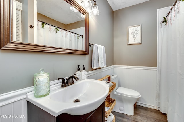 1597 Old Lake Rd, Brandon, MS 39042 - full bath with toilet, wainscoting, wood finished floors, and vanity