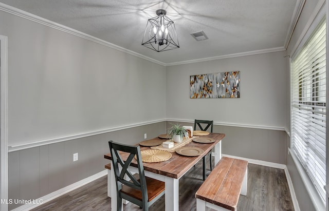 1597 Old Lake Rd, Brandon, MS 39042 - dining area with a chandelier, wood finished floors, healthy amount of natural light, ornamental molding, and a textured ceiling
