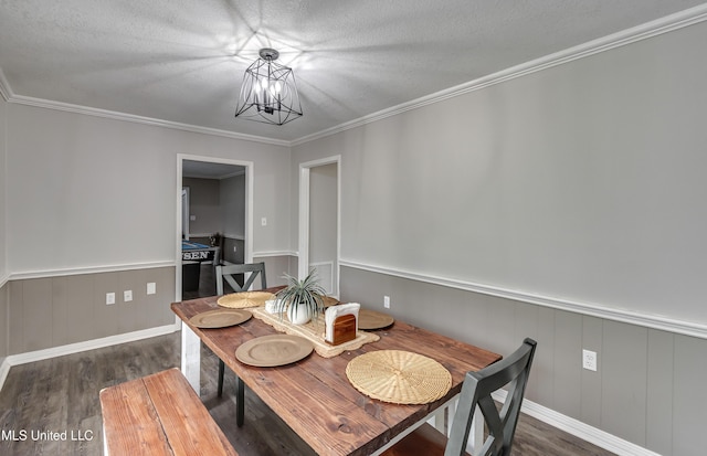1597 Old Lake Rd, Brandon, MS 39042 - dining area with wood finished floors, a wainscoted wall, a chandelier, a textured ceiling, and crown molding