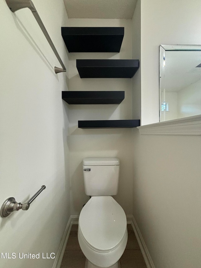 bathroom featuring toilet and tile patterned flooring