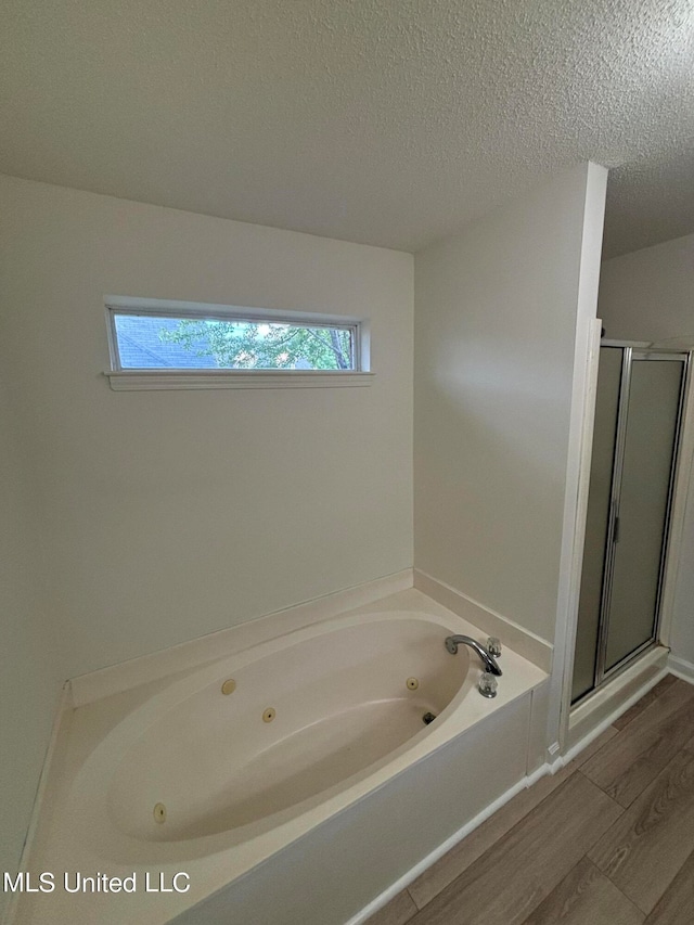 bathroom featuring hardwood / wood-style floors, shower with separate bathtub, and plenty of natural light