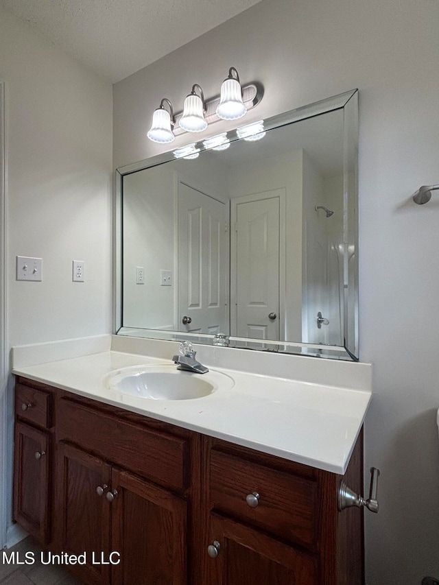 bathroom with vanity and a textured ceiling