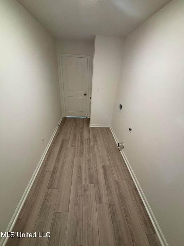 interior space featuring light hardwood / wood-style floors and electric dryer hookup