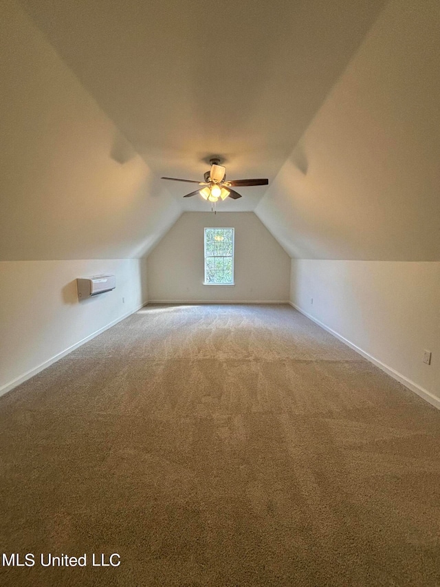 additional living space featuring vaulted ceiling, light colored carpet, and ceiling fan