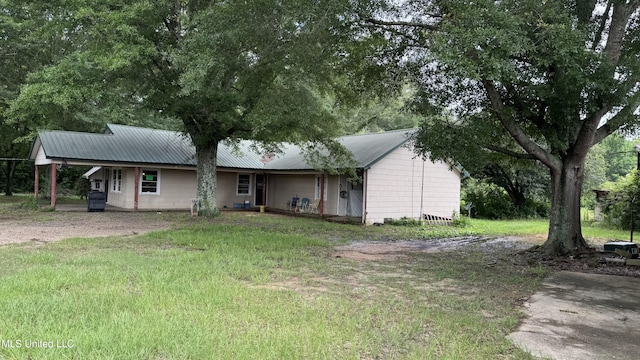 4513 Lawrence Hazel Rd, Lawrence, MS 39336 - view of front facade with metal roof, a front lawn, and an attached carport