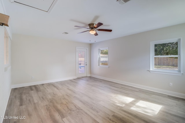 empty room with light wood-type flooring, a wealth of natural light, and ceiling fan