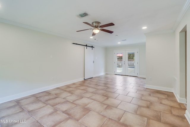 unfurnished room with french doors, ceiling fan, a barn door, ornamental molding, and light tile patterned flooring