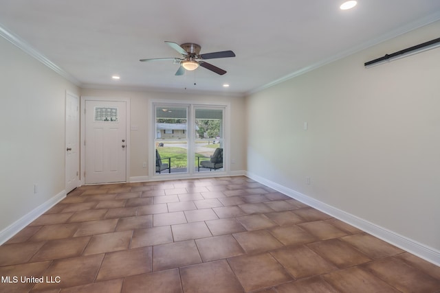 interior space with a barn door, ceiling fan, and crown molding