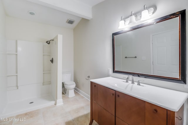 bathroom featuring tile patterned floors, vanity, toilet, and walk in shower