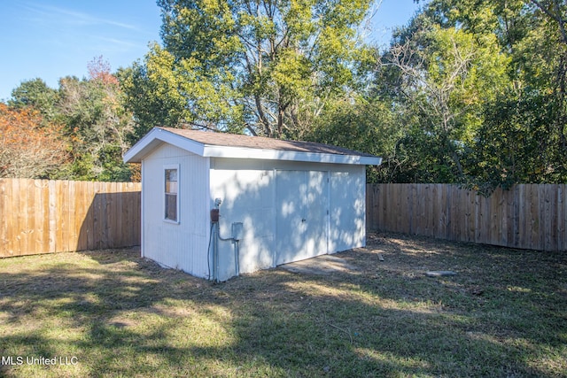 view of outbuilding with a yard