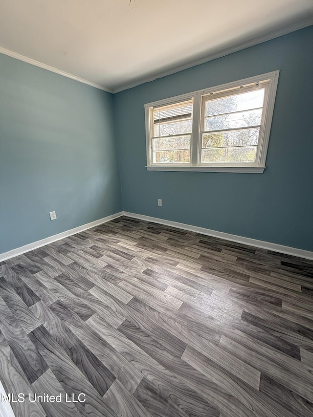 spare room featuring baseboards and ornamental molding