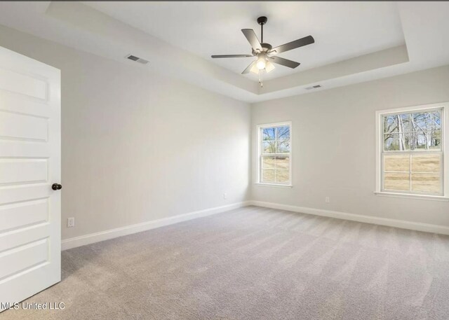 3752 Roland Dr, Southaven, MS 38672 - empty room featuring a tray ceiling, baseboards, light colored carpet, and ceiling fan