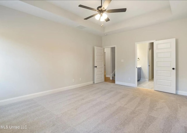 3752 Roland Dr, Southaven, MS 38672 - unfurnished bedroom featuring light colored carpet, baseboards, a raised ceiling, and connected bathroom
