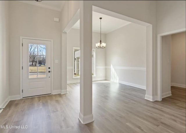 3752 Roland Dr, Southaven, MS 38672 - foyer with a chandelier, wood finished floors, baseboards, and crown molding