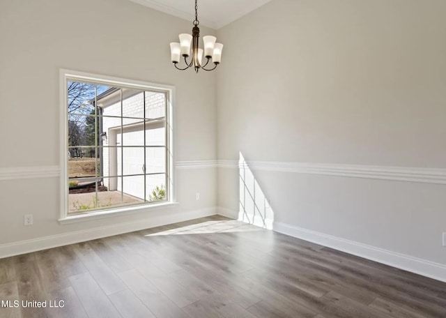 3752 Roland Dr, Southaven, MS 38672 - spare room featuring a chandelier, dark wood-style flooring, and baseboards